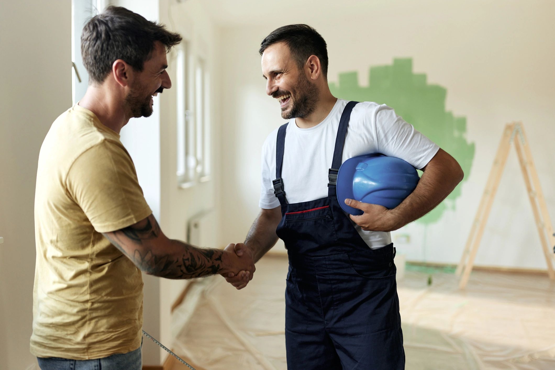 Client and contractor handshake during a home improvement consultation