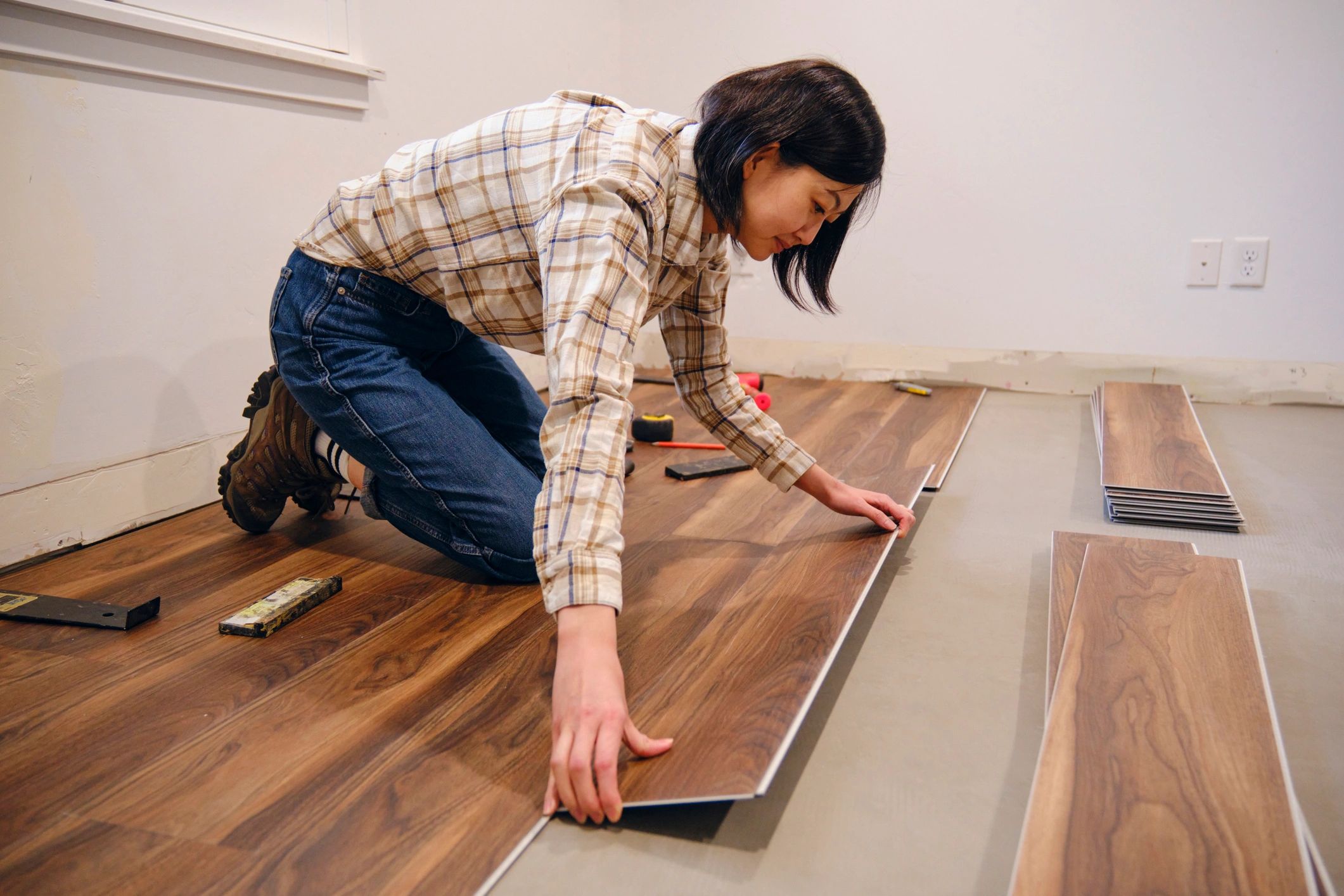 Installer laying new flooring during a remodel