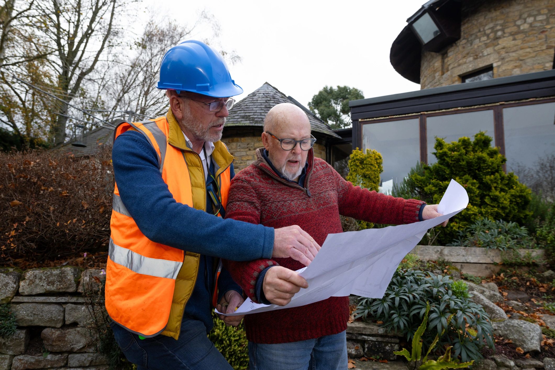 Contractor reviewing renovation plans with a homeowner