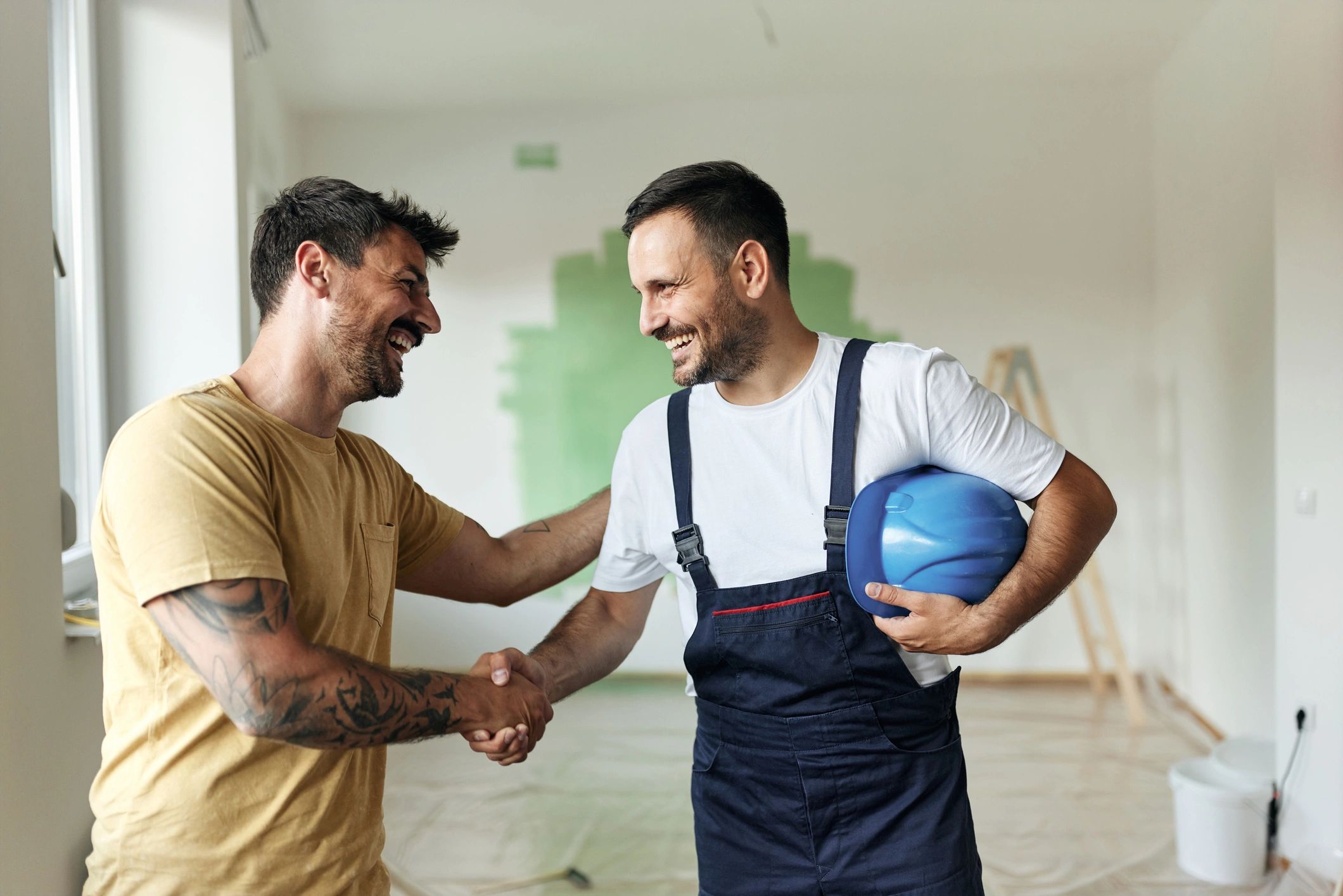 Homeowner and contractor handshake after agreeing on work